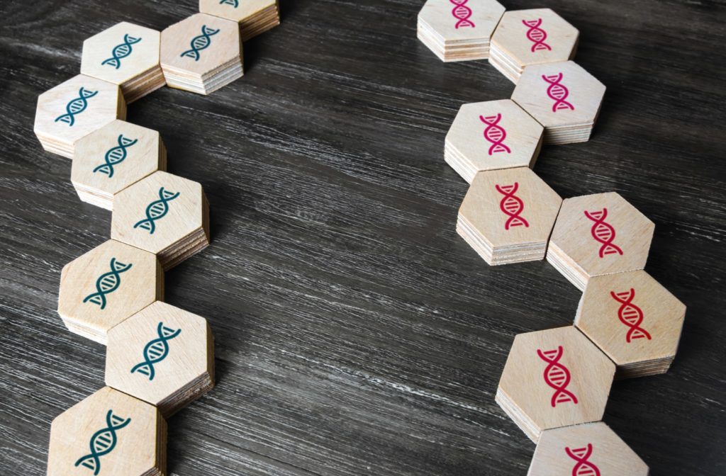 Wooden blocks with DNA symbols on them, stacked together to represent genetic linkage