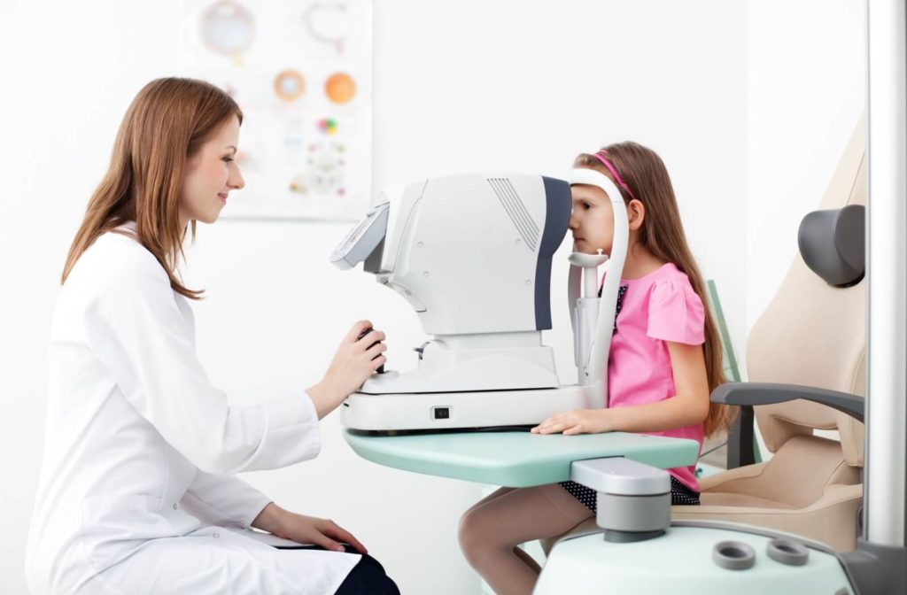 An optometrist giving a child an eye exam