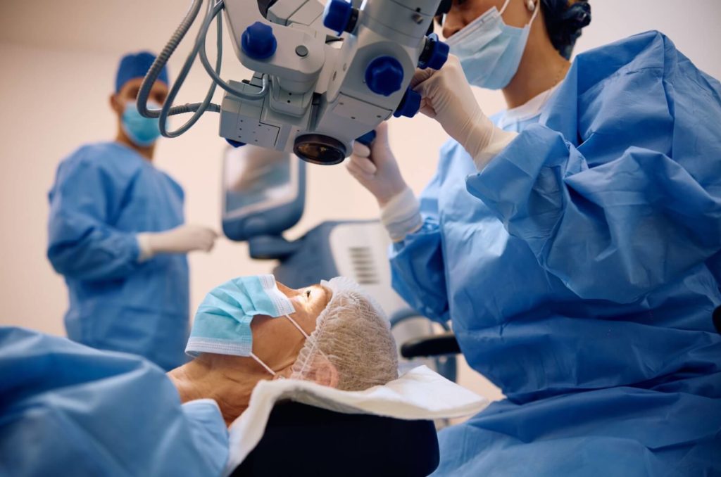 A mature woman undergoing cataract surgery in the surgery room.  