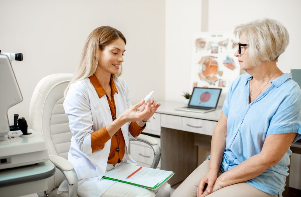 An optometrist explaining the importance of dry eye management to a patient.