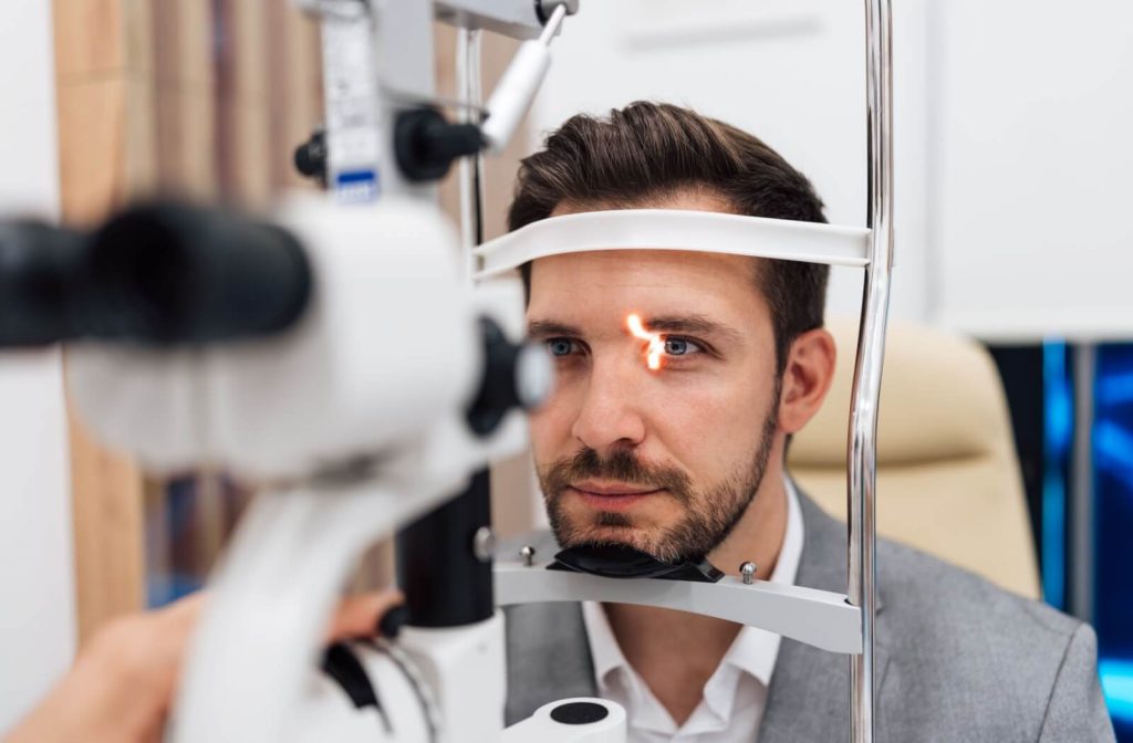 Someone getting their eyes examined by an optometrist.
